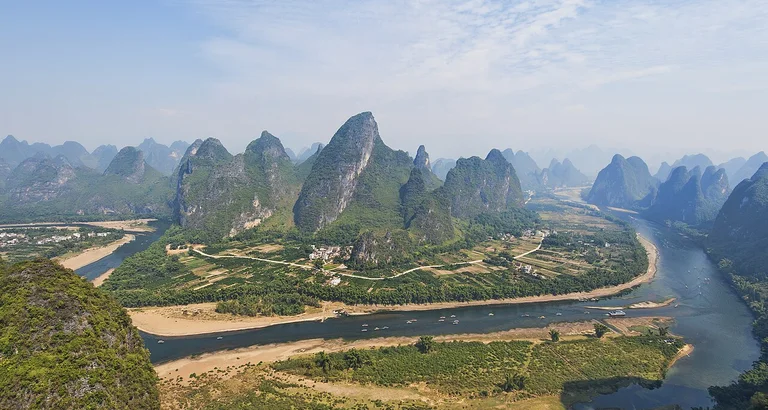 Admire the sweeping panorama of the Li River winding through karst hills