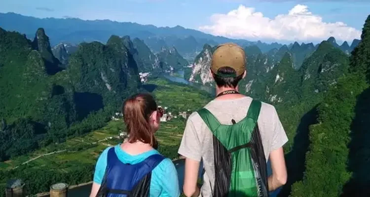 Admire the sweeping panorama of the Li River winding through karst hills